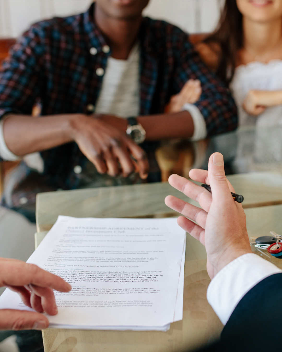 Person explaining documents to a couple